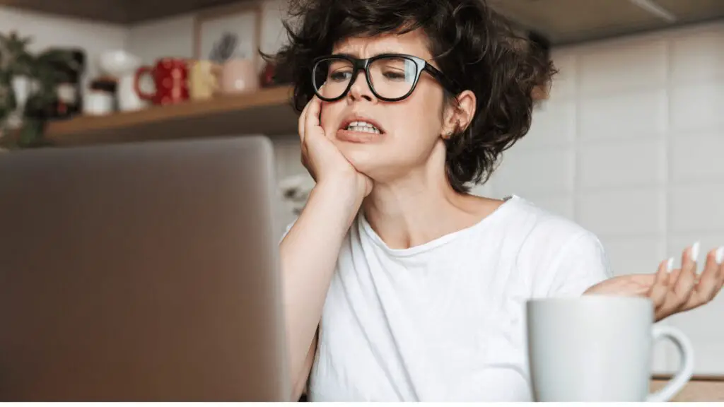 frustrated woman looking at laptop